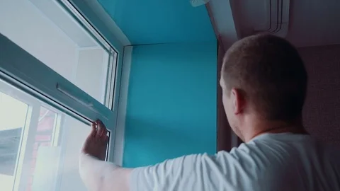 Worker repairs a window Stock Footage 81502218