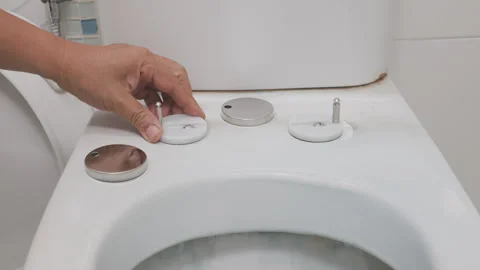 Worker replace hinge rubber plug and Screws for Toilet Seat. Stock Footage 318204347