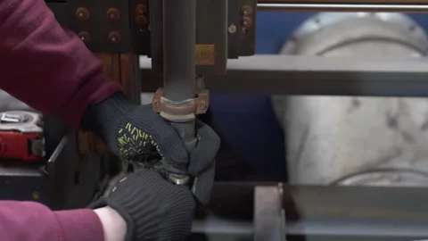 A worker replaces a plasma electrode on a CNC machine. Stock Footage 276263576