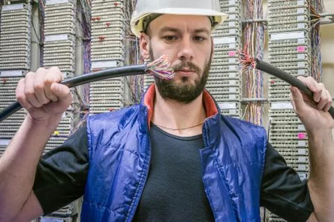 Worker restores the connection in the data center server room. Engineer in a  库存照片