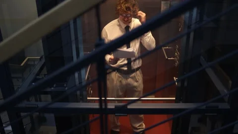 Worker reviewing documents in elevator Stock Footage 333974857