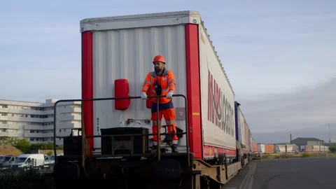 Worker Riding Rear of MARS Logistics Freight Train Stock Footage 338371665