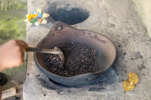 Worker Roasting Coffee Beans on Traditional Stove Stock Photos