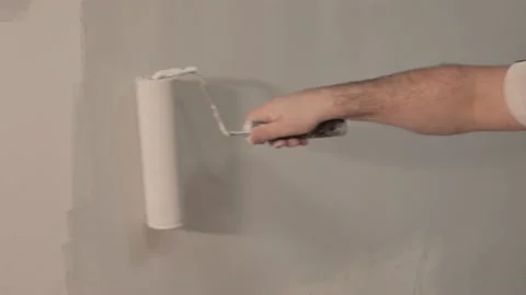 Worker roller paints the wall, Construction industry Video stock 130971060