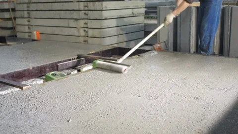 Worker with roller smoothes cement. Workers in the workshop of the House Stock Footage 125491542