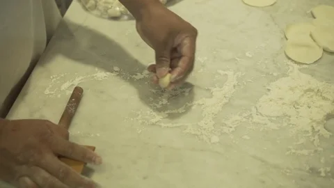 Worker rolling out dumplings. Slow motion.  Video stock 78885832