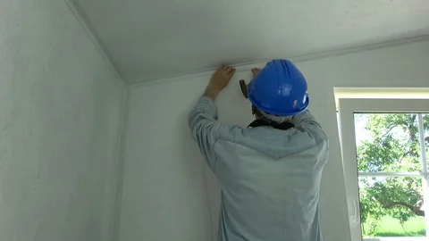Worker in room fixing new electricity wire on wall Stock Footage 87917629