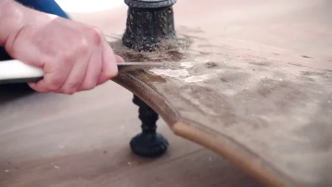 Worker rubbing old wooden surface with industrial knife, handyman restoring Stock Footage 233921799