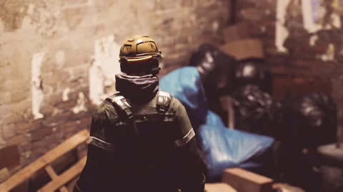 Worker in safety gear inspecting warehouse area with discarded materials Stock Footage 319493647