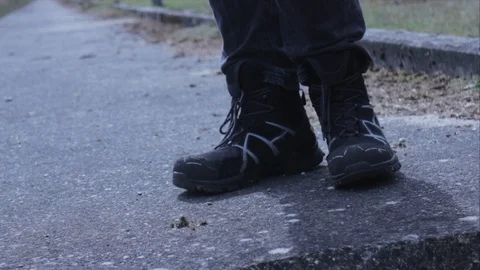 Worker in safety shoes standing on concrete Stock Footage