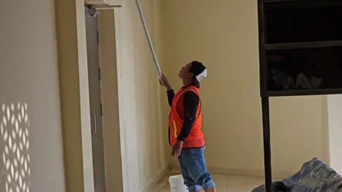 Worker In Safety Vest Using A Long Pole For High Wall Maintenance Or Renovation Stock Footage 340001856
