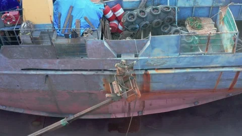 The worker sand-sprinkler processes a ship board. Stock Footage 164549562