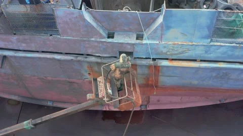 The worker sand-sprinkler processes a ship board. Stock Footage 165370334