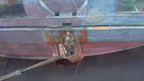 The worker sand-sprinkler processes a ship board. Stock Footage 165938186