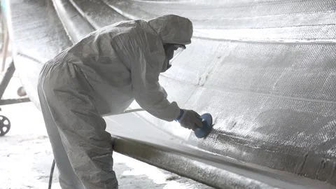 Worker sanding down a boat's frame 4 Stock Footage 162345727