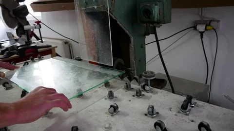 Worker sanding, edging 4 mm thick glass Stock Footage 259486711