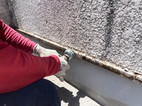 Worker sands the surface. cleans old paint Stock Photos