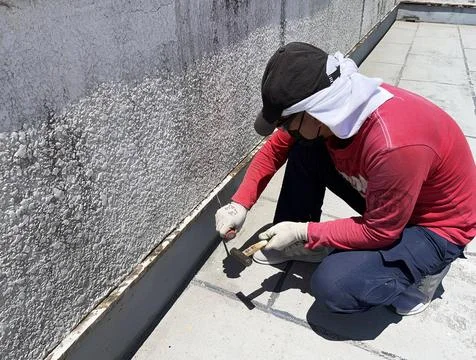 Worker sands the surface. cleans old paint Stock Photos