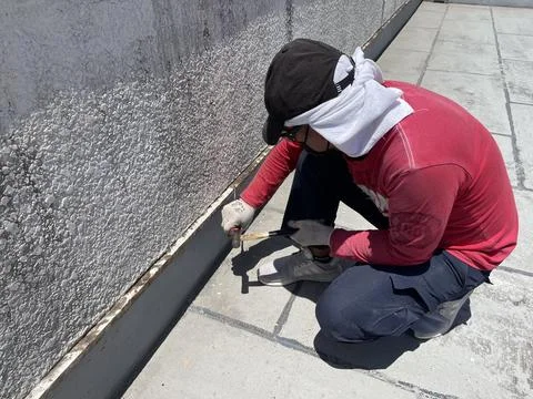 Worker sands the surface. cleans old paint Stock Photos