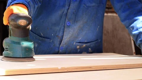 Worker sands wooden surface with random orbital sander 스톡 동영상 335028277