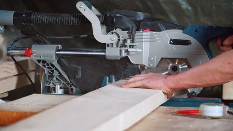 Worker sawing a board with a circular saw. Stock Footage 126775386