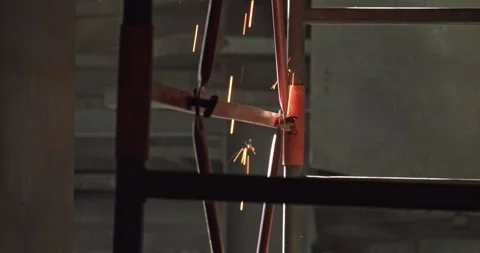 Worker sawing iron with a hand grinder and sparks Stock Footage 132402971