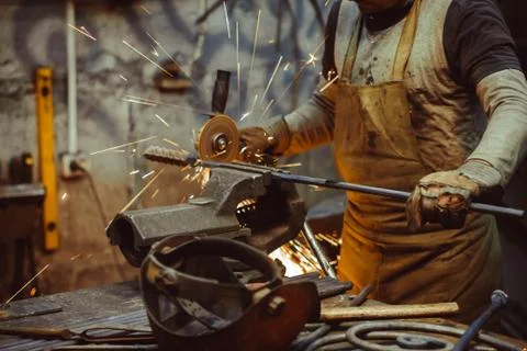 Worker sawing the iron Stock Photos
