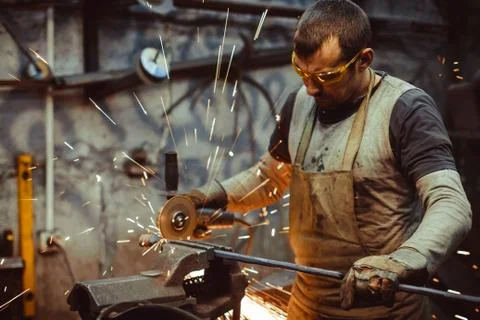Worker sawing the iron Stock Photos