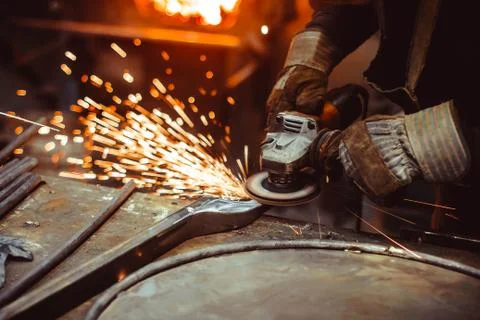 Worker sawing the iron Stock Photos