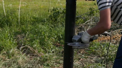 Worker sawing a pipe with a chain saw Stock-Footage 114057694