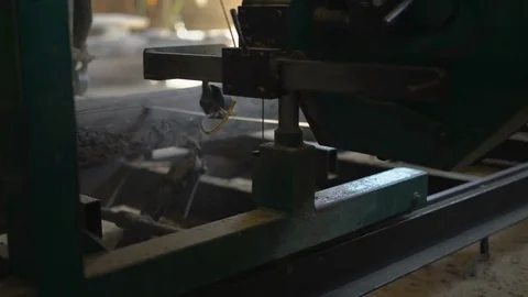 Worker Sawmill,cuts The Board Circular Saw With Logs Attached to the Frame Stock Footage 76642813