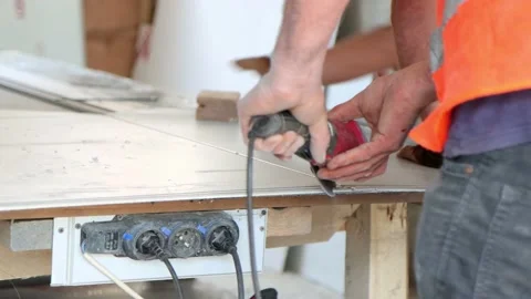 Worker saws aluminium panel at construction site Stock Footage 208561481
