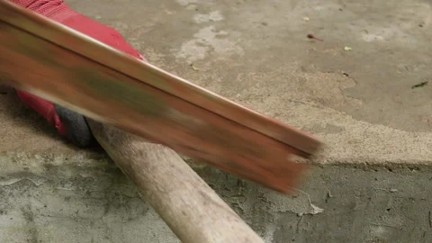 A worker saws off a board with a hand saw. Stock Footage 156445768