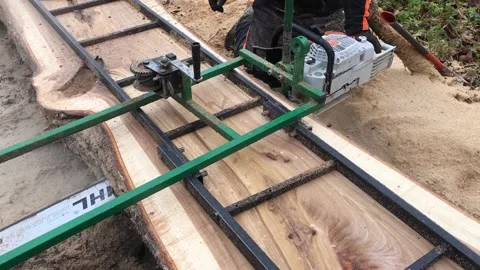 A Worker Saws A Large Log With A Stihl Gasoline Video Video stock 296326837