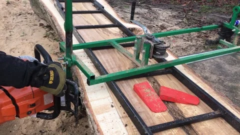 A Worker Saws A Large Log With A Stihl Gasoline Video Video stock 296326840