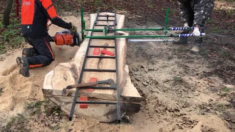 A Worker Saws A Large Log With A Stihl Gasoline Video Video stock 296326846
