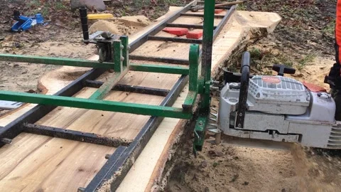 A Worker Saws A Large Log With A Stihl Gasoline Video Video stock 296326847