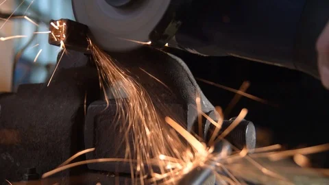 A worker saws metal with a cutting machine. Slow-motion close-up Video stock 128386866