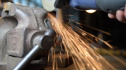 A worker saws metal with a cutting machine. Slow-motion close-up Video stock 128411454