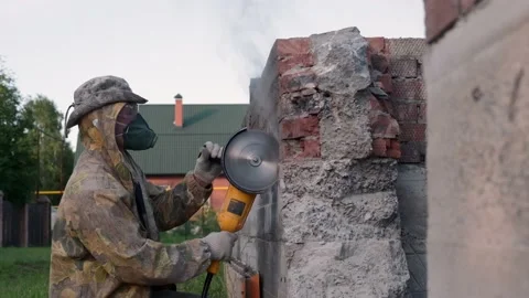 Worker saws stone with circular saw for repairing. Power-saw with disk. Slow Video stock 133292684