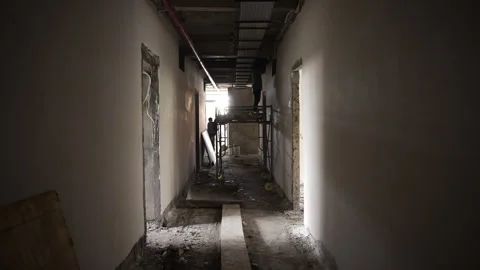 Worker on scaffold at construction inside unfinished building Video stock 271570890