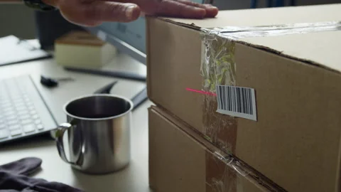 Worker Scanning Barcode on Cardboard Box for E-commerce Shipping 動画素材 337305543