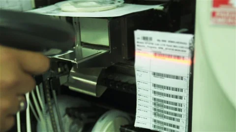 Worker Scanning Barcode Sheet with Handheld Laser Reader in Factory Setting Stock Footage 88479302
