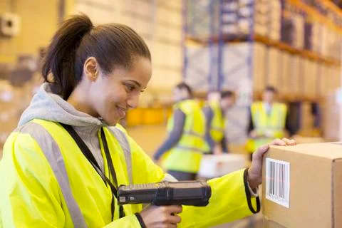 Worker scanning box in warehouse Stock Photos