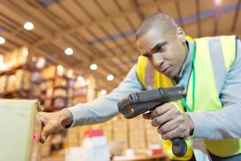 Worker scanning boxes in warehouse Stock Photos