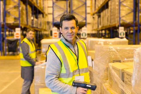 Worker scanning boxes in warehouse Stock Photos