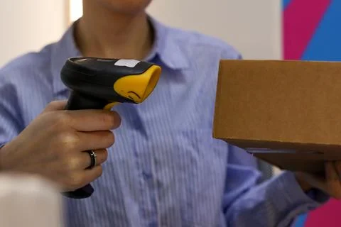 Worker scanning package with handheld barcode reader Stock Photos