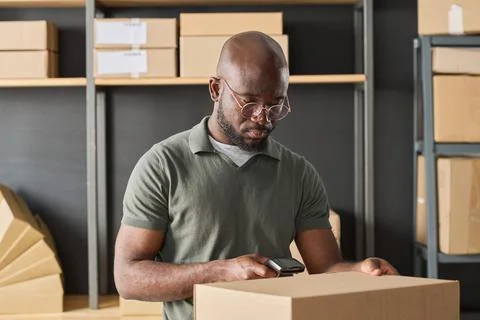 Worker scanning parcel with scanner 스톡 사진