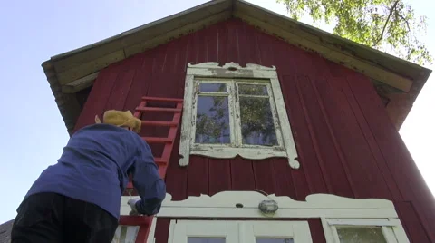 Worker  scraping old paint from house window Stock Footage 41332935