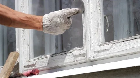 Worker Scraping Old Paint From House Video stock 69187945